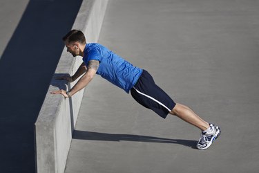 Man doing pushups at urban setting