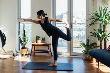 Person doing yoga exercise at home in living room