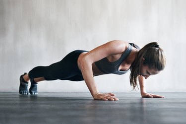 a young adult wearing black workout clothing does 30 push-ups every day